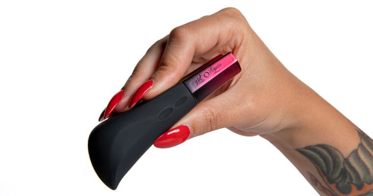A hand holds the red and black Hot Octopuss Amo bullet vibrator.