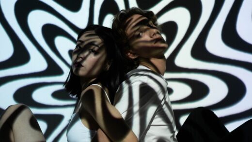 a young couple sitting back to back