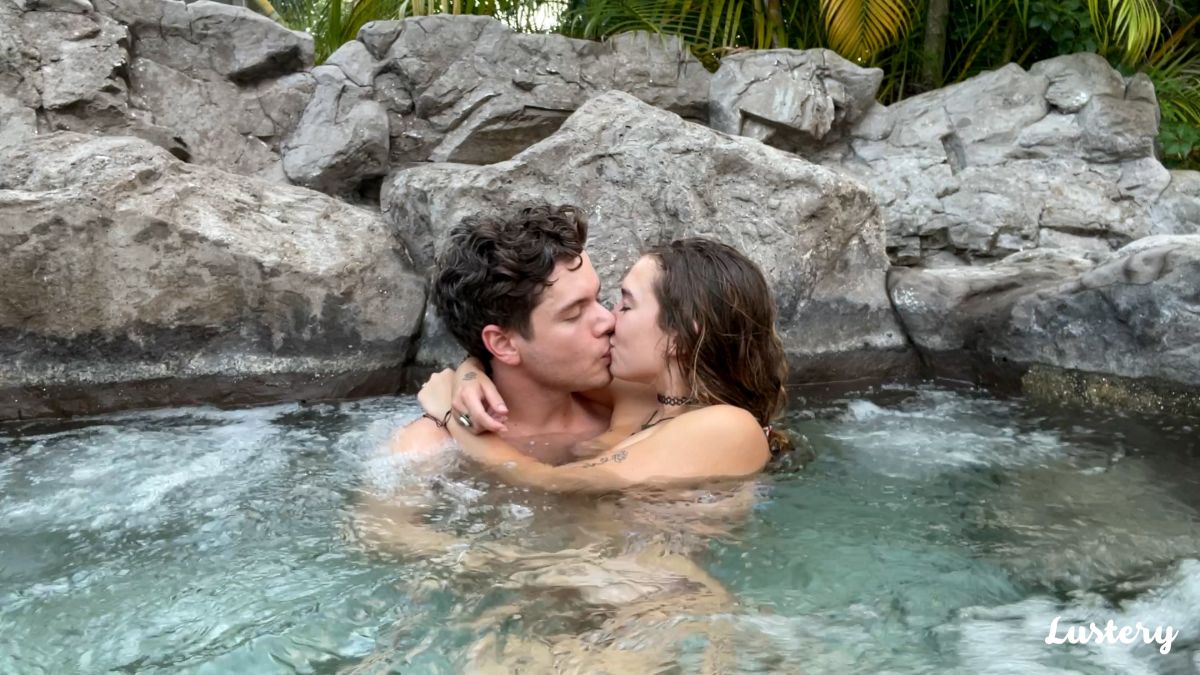 A shot of a couple kissing in a rock pool for Lustery, which makes female friendly porn for couples.